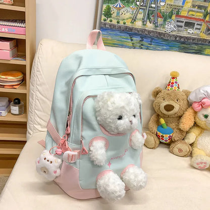 Macaron colour nylon school backpack with curved straps, shown in yellow pink, with a pendant attached.