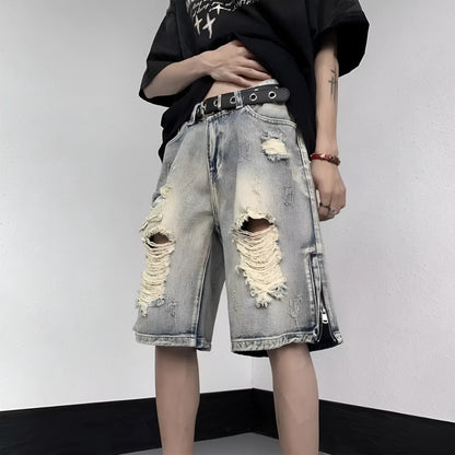 A pair of faded blue denim shorts with a tattered, distressed finish and a loose wide-leg silhouette.