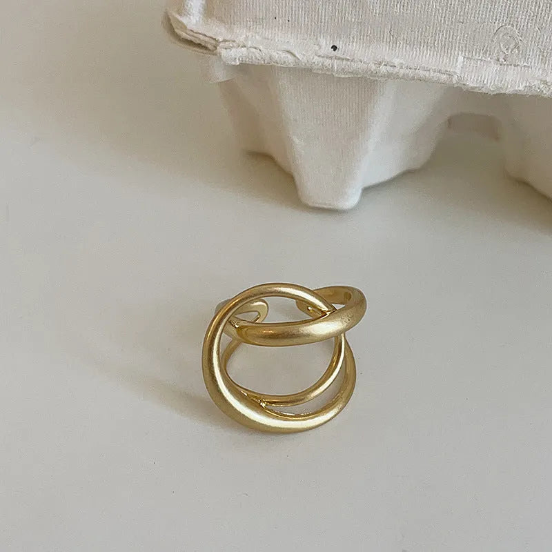 Three-dimensional interlaced geometric open ring in matte metal with real gold plating