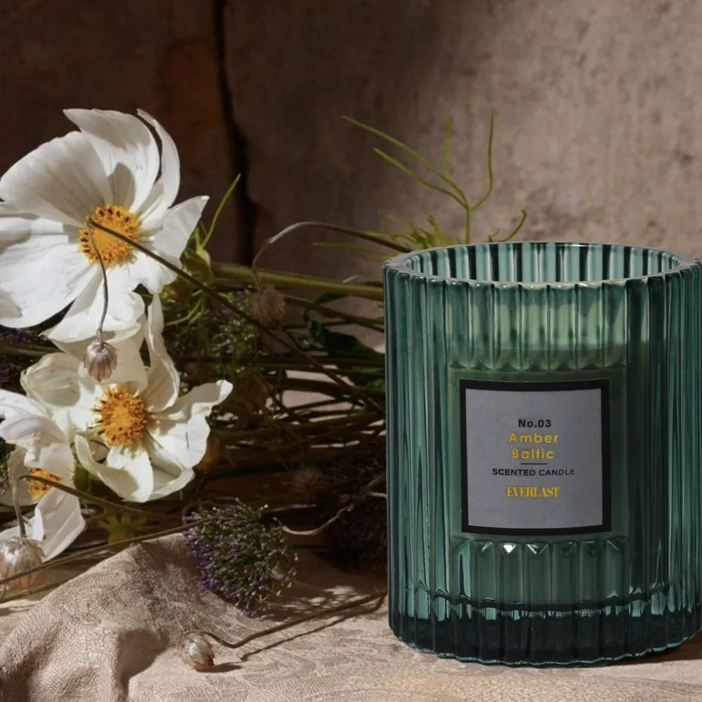 Soy wax aromatherapy candle in cylindrical shape showing red, green and amber colour options