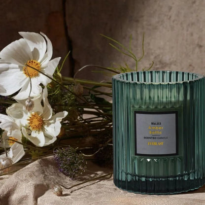 Soy wax aromatherapy candle in cylindrical shape showing red, green and amber colour options