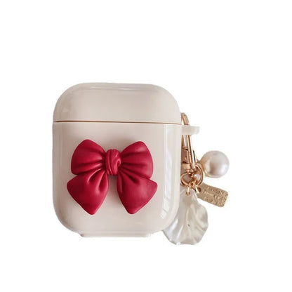 Beige red bow shell patterned TPU clamshell protective case for AirPods Pro earphones.