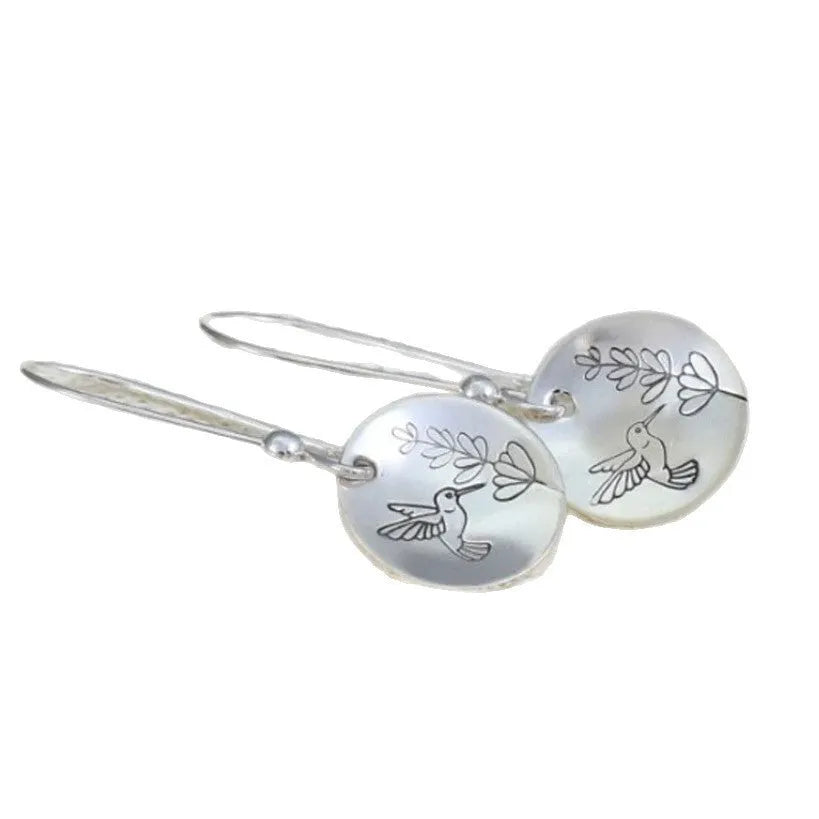 Silver zinc alloy women's earrings with glossy round shape featuring bird and flower designs