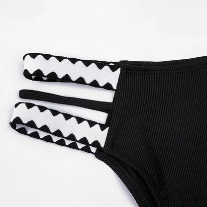 Black women's hollowed-out split swimsuit bikini set on a model.