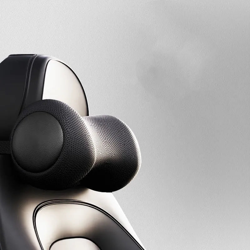 Black car massage cushion with headrest and lumbar support on a car seat, showing wired controller.