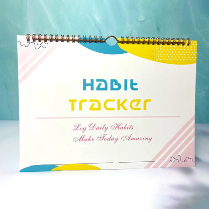 Habit tracking planner book open showing 12 internal pages, measuring 21cm by 28cm.