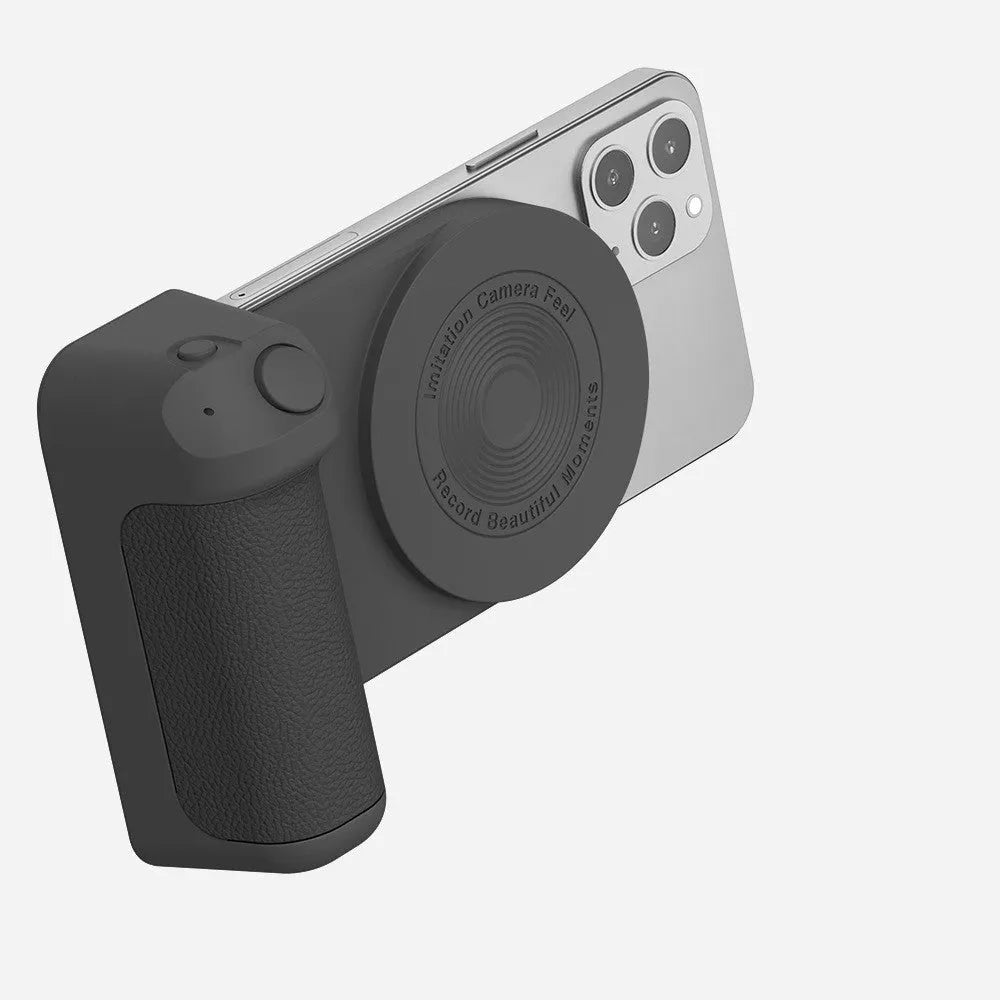Black magnetic phone camera grip with rotatable bracket and ergonomic PU leather handle on a table.