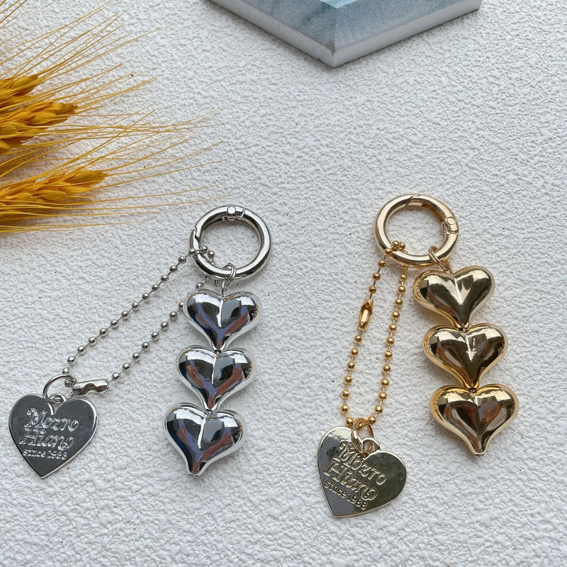 Acrylic key ring featuring a peach and heart design with electroplated finish in choice of black, gold, or white, a decorative key accessory with love motif for personalising keys or bags