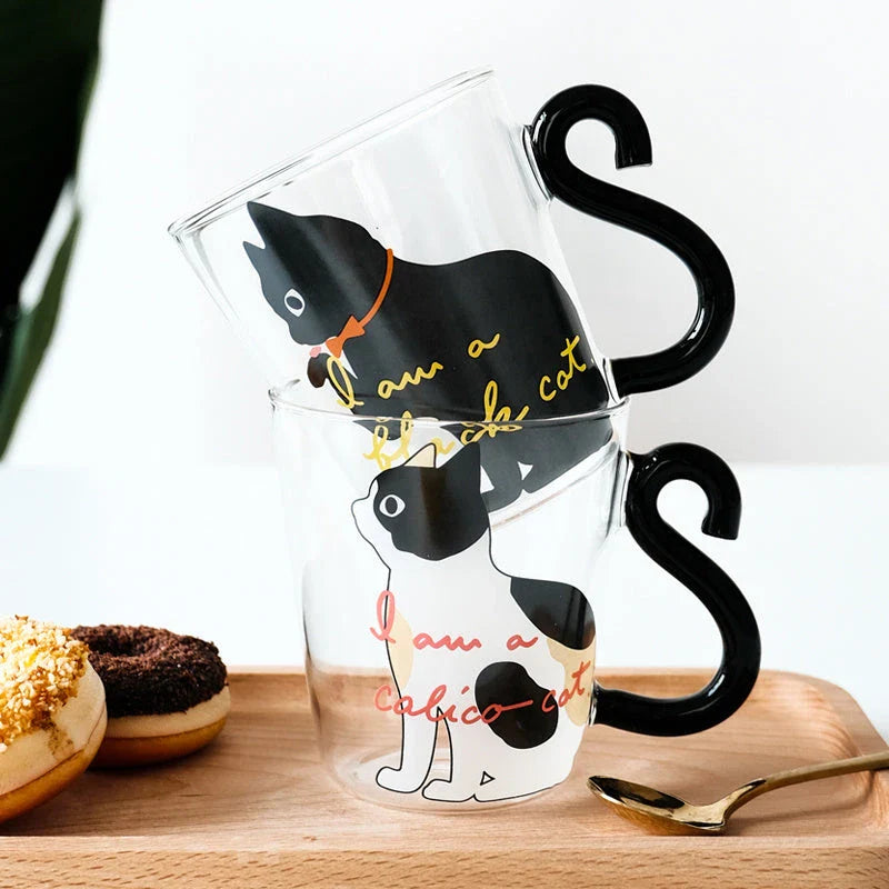 Adorable cat-themed glass mug with a whimsical cat-shaped handle, perfect for coffee, tea, and juice lovers