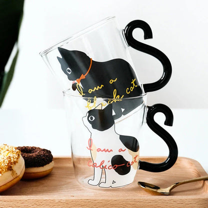 Adorable cat-themed glass mug with a whimsical cat-shaped handle, perfect for coffee, tea, and juice lovers