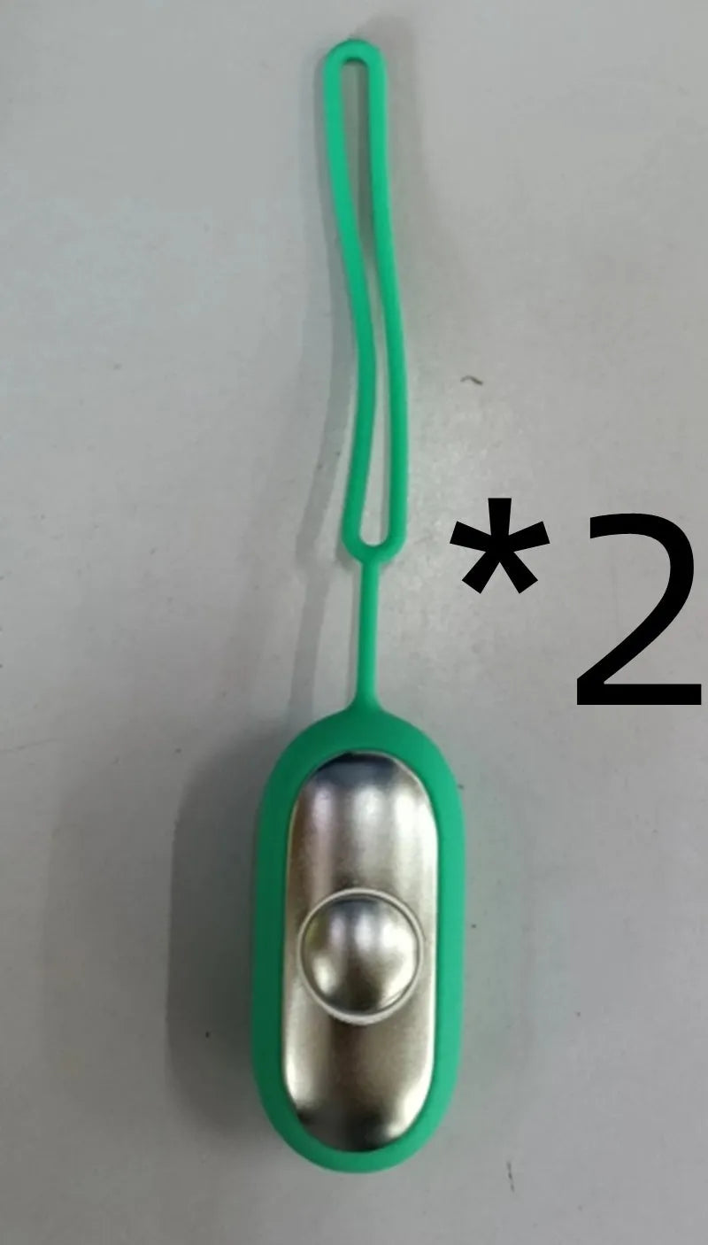 Hand-held micro-current sleep aid device in grey, green, or orange with round button and USB charging port