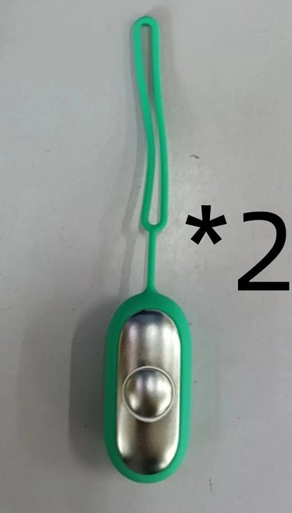 Hand-held micro-current sleep aid device in grey, green, or orange with round button and USB charging port