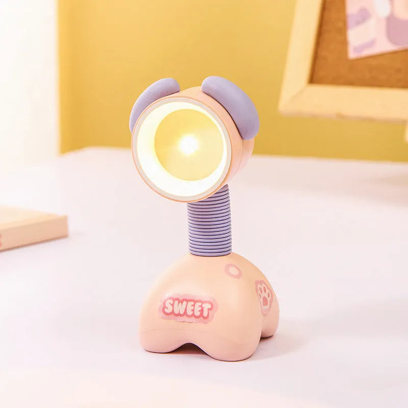 Colourful cartoon character magnetic DIY night light on a desk with adjustable head.