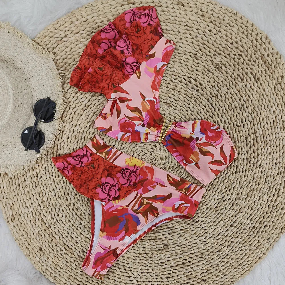 Women's one-shoulder ruffled high-waist bikini with pink background and red flower pattern