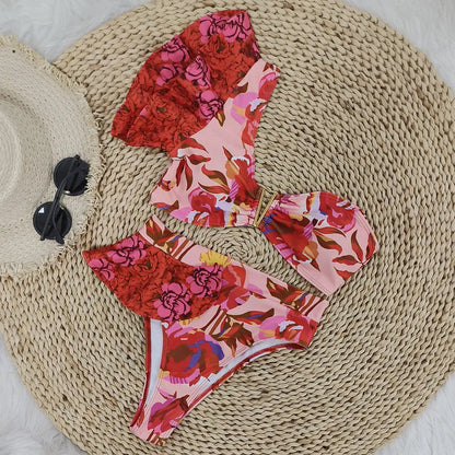 Women's one-shoulder ruffled high-waist bikini with pink background and red flower pattern