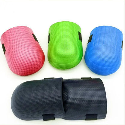 A pair of thick EVA foam kneepads in blue, shown on a tile floor.
