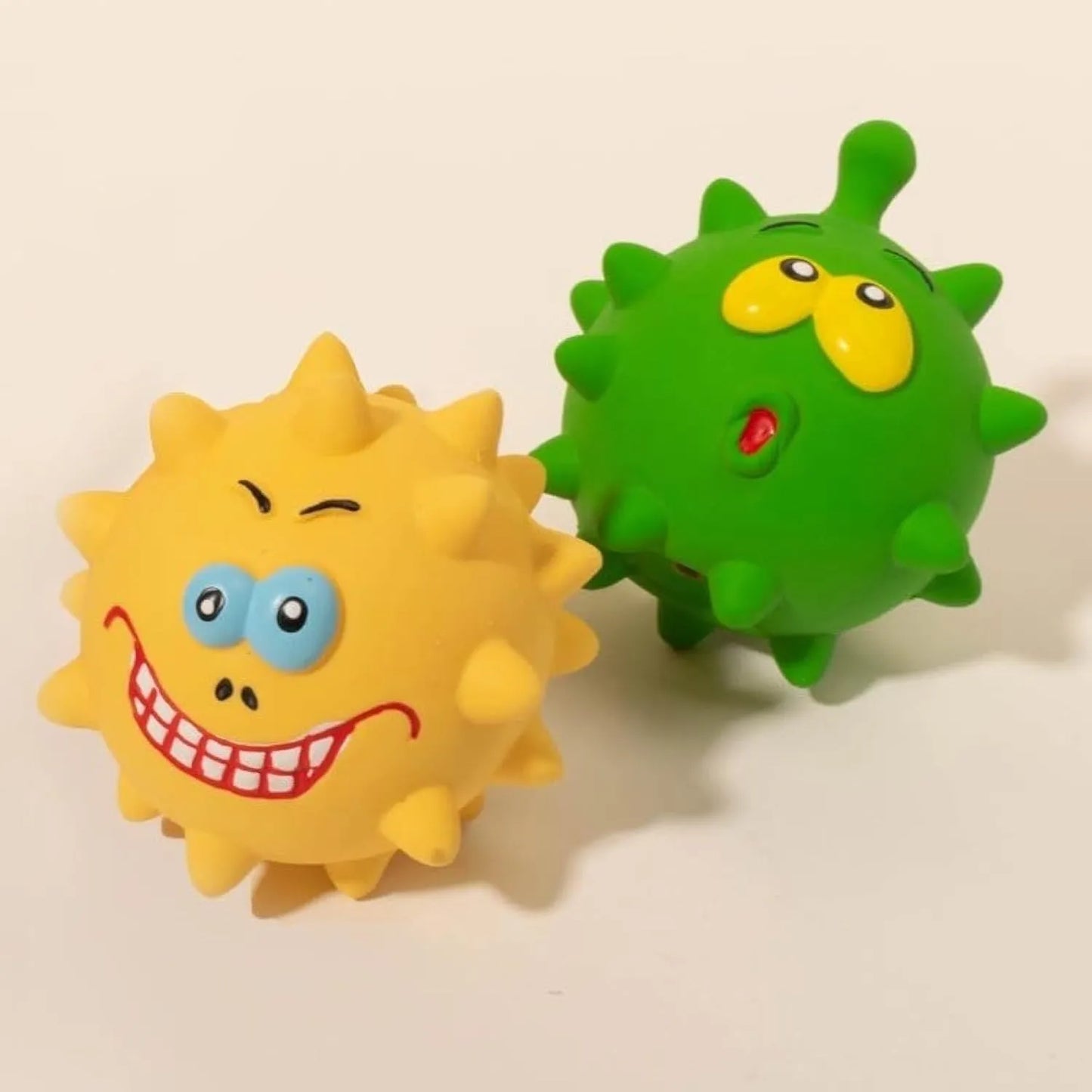 Four natural latex dog squeaky toys with bumpy surfaces and cute faces in blue, green, red, and yellow colours