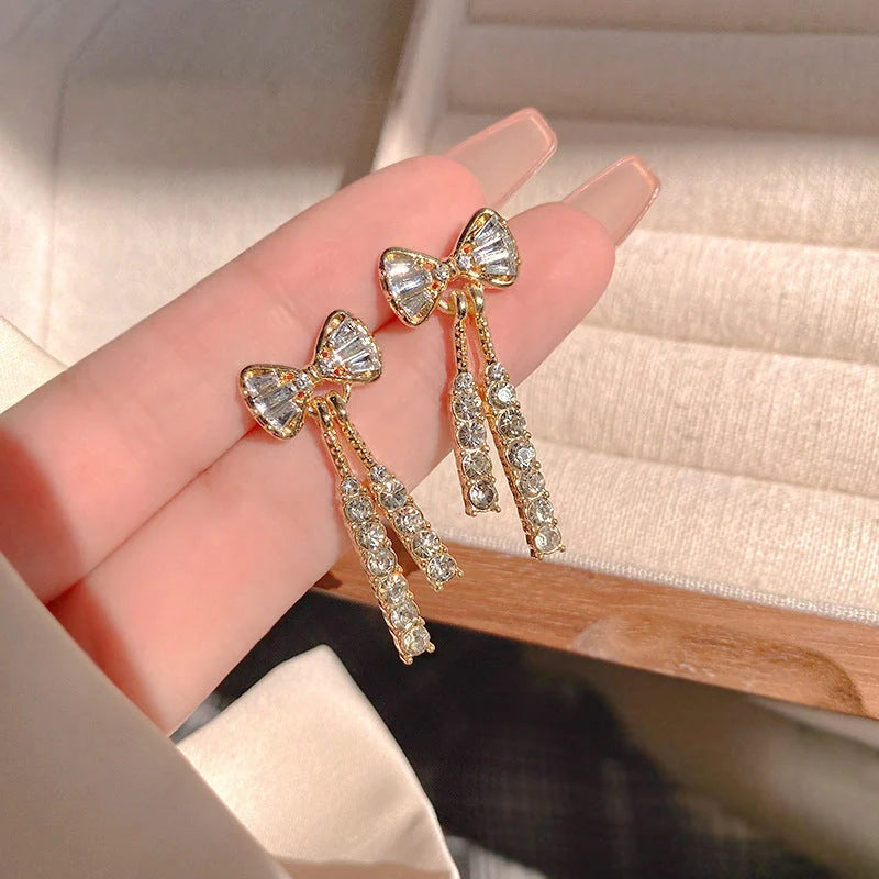 Elegant gold bow diamond crystal earrings for women, perfect for adding a touch of glamour to any outfit.