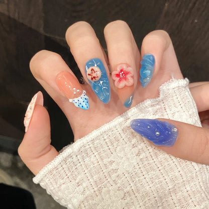 Three-dimensional plastic wearable armour set with carved jellyfish decorations in almond nail colour.