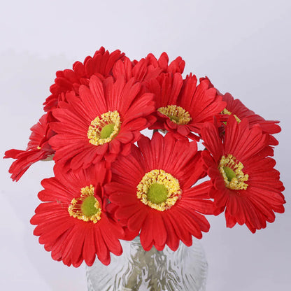 Silk artificial flower bouquet in a white polyurethane pot on a wooden table.