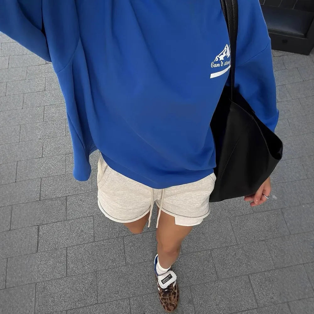 Blue and white vintage stripe cotton sweater with a loose fit, round neck, and long sleeves on a man.