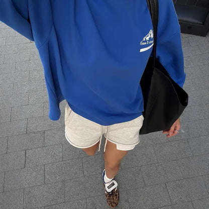 Blue and white vintage stripe cotton sweater with a loose fit, round neck, and long sleeves on a man.