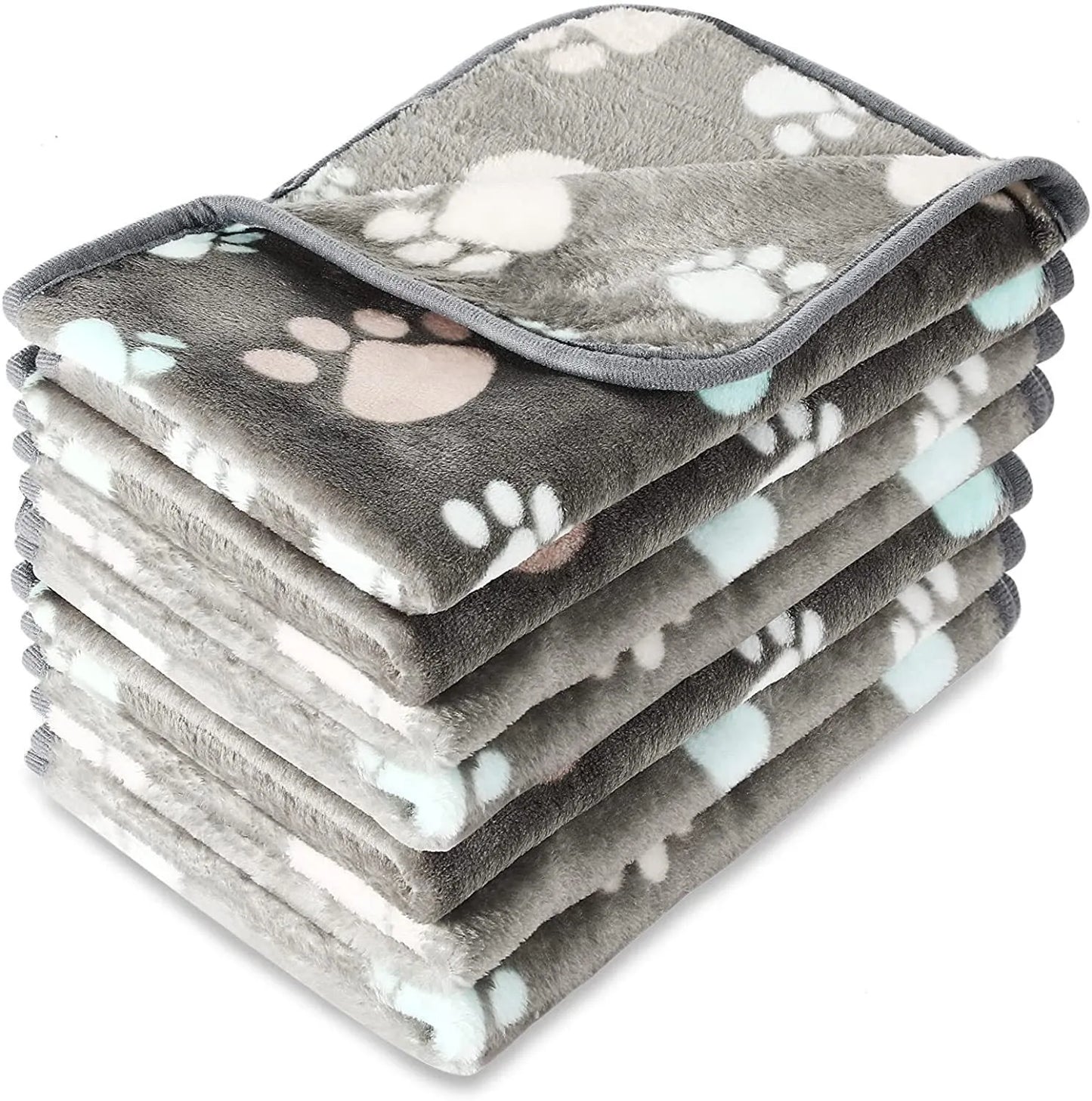 Coral fleece dog blanket with paw print pattern, shown in beige colour, laid flat to show size and soft texture.