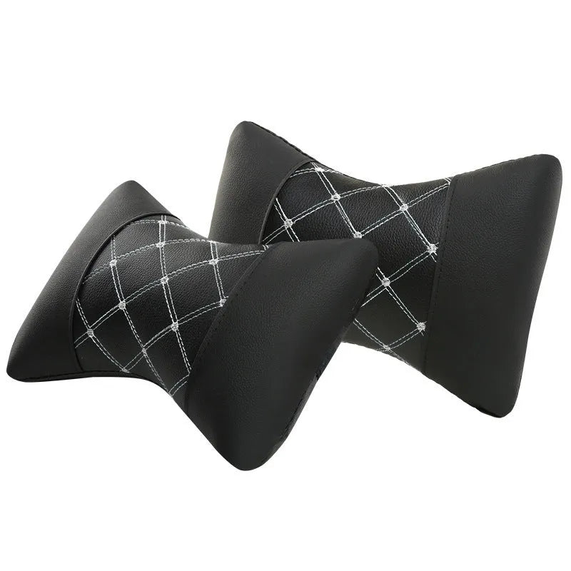 Black leather quilted car headrest with diamond pattern and red stitching lines on cervical support pillow
