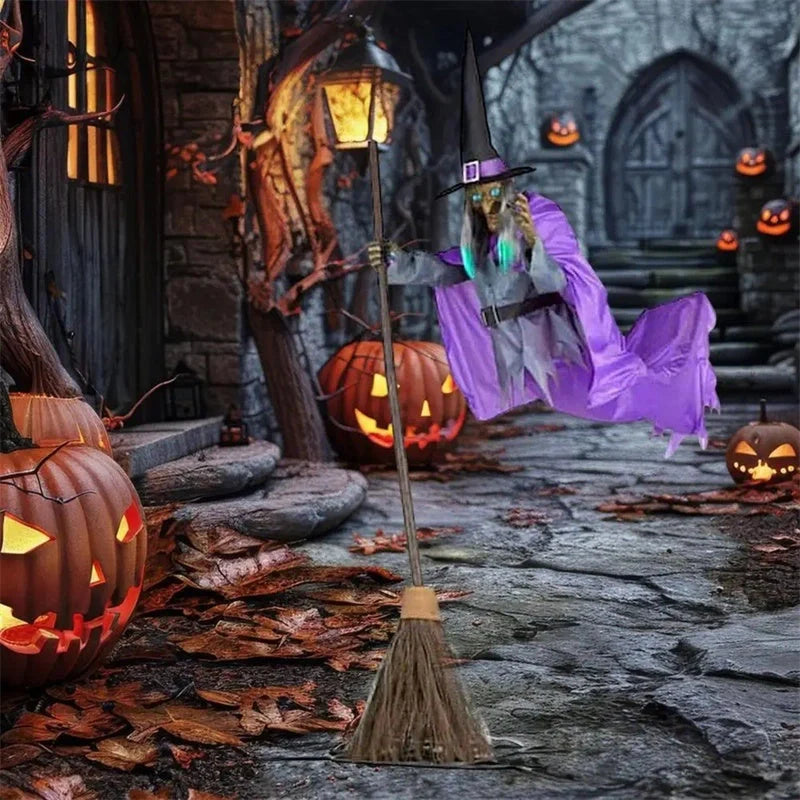 Floating witch Halloween decoration with broom, lifelike scary face, and purple hovering skirt