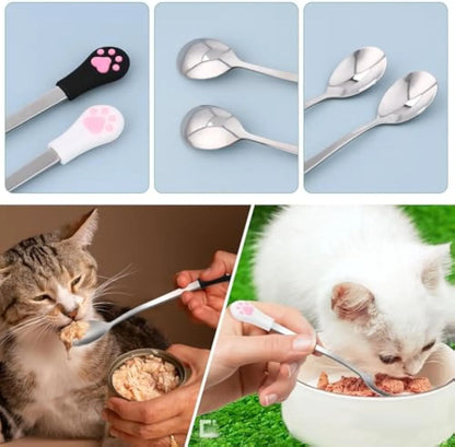 Two pet food spoons with cat paw designs - one white and one black with stainless steel and silicone construction