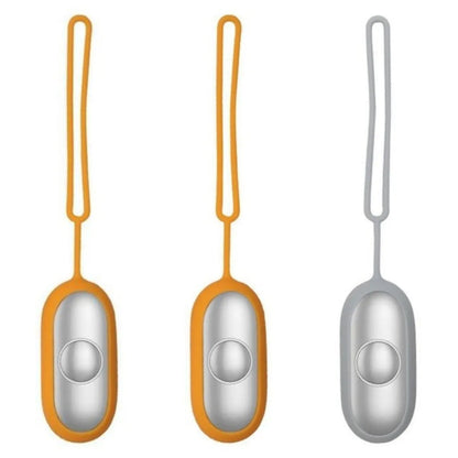Hand-held micro-current sleep aid device in grey, green, or orange with round button and USB charging port
