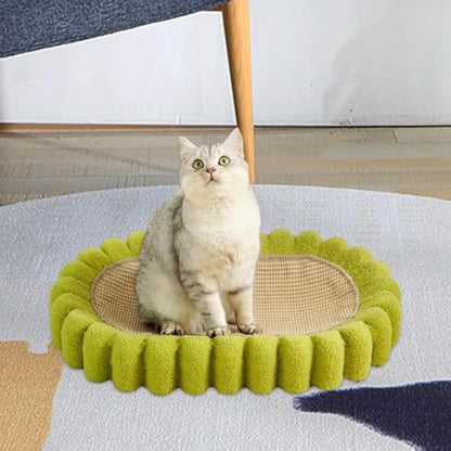 Green oval sisal cat scratching pad and lounge bed on a wooden floor.