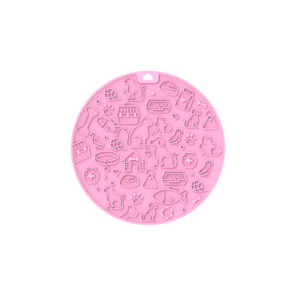 Round blue silicone pet licking mat with textured surface and a clear central suction cup, shown on a tile floor.