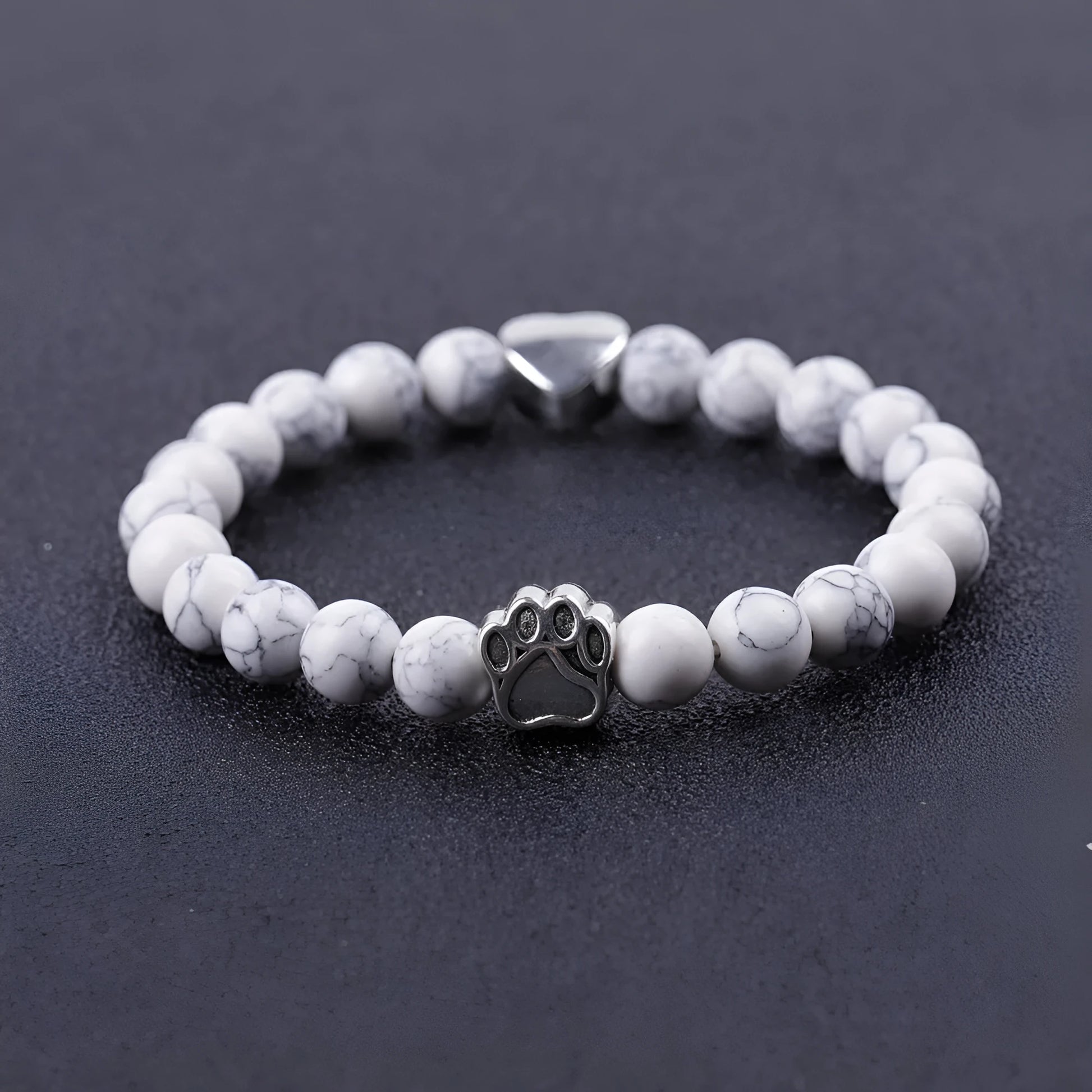 Tiger's eye stone bracelet with dog paw and Indian agate beaded designs on a wrist.
