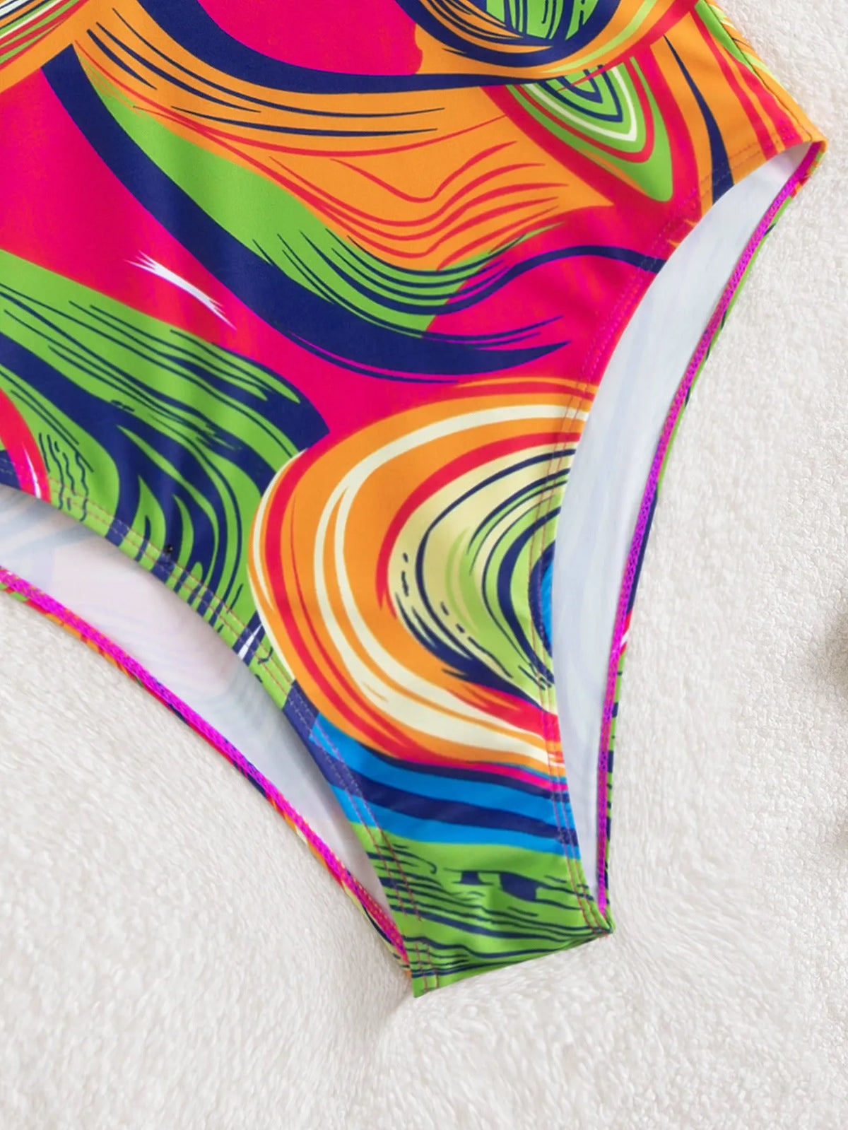 Women's deep V neck one-piece swimsuit with spaghetti straps in printed polyester fabric.