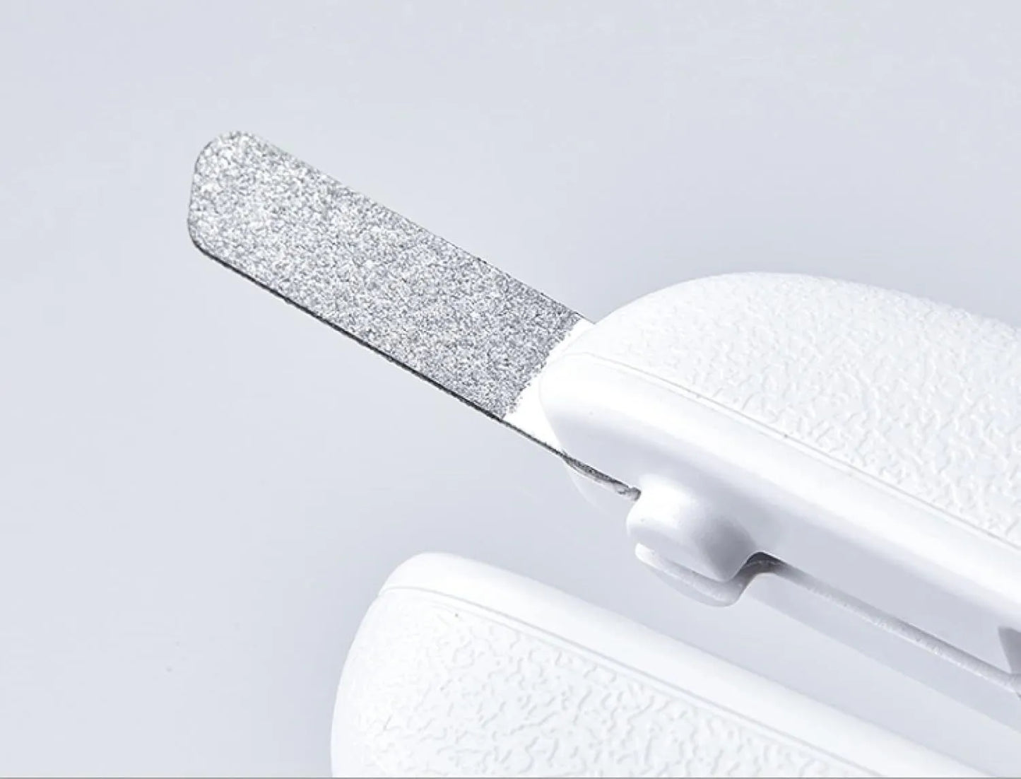 White LED pet nail clippers with a transparent safety guard and a nail file on a grey background.