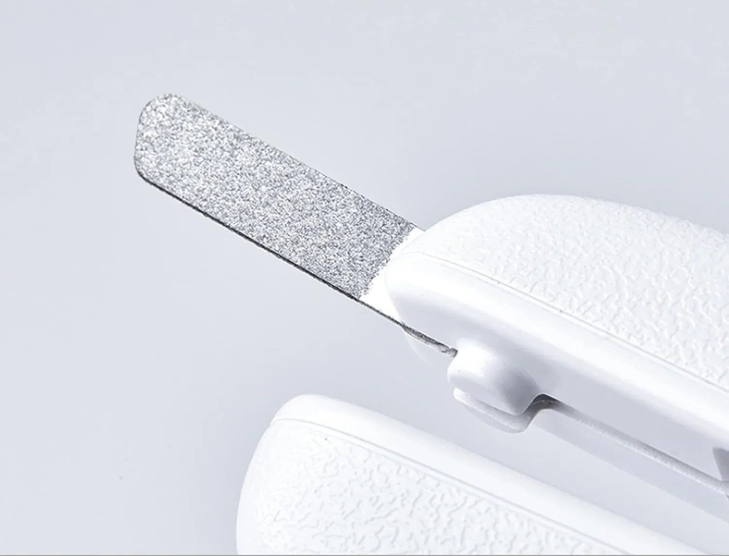 White LED pet nail clippers with a transparent safety guard and a nail file on a grey background.