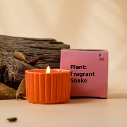 Soy wax aromatherapy candle inside a handmade ceramic cup, shown in a mint green colour.