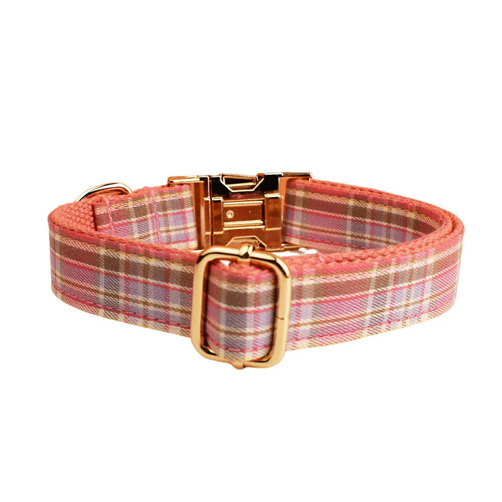 Red plaid cloth dog collar and leash set with matching bow on a white background