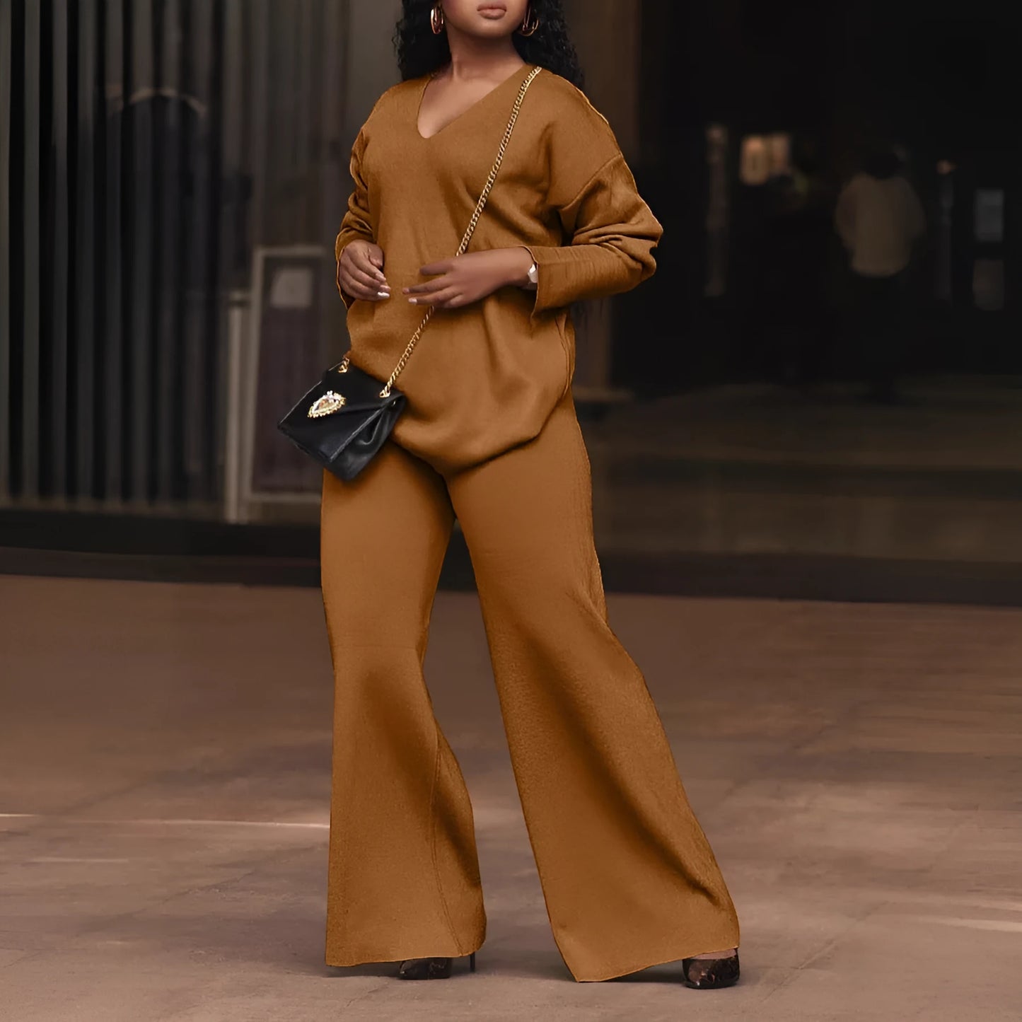 Women's brown suede two-piece suit with split sleeves on top and matching trousers