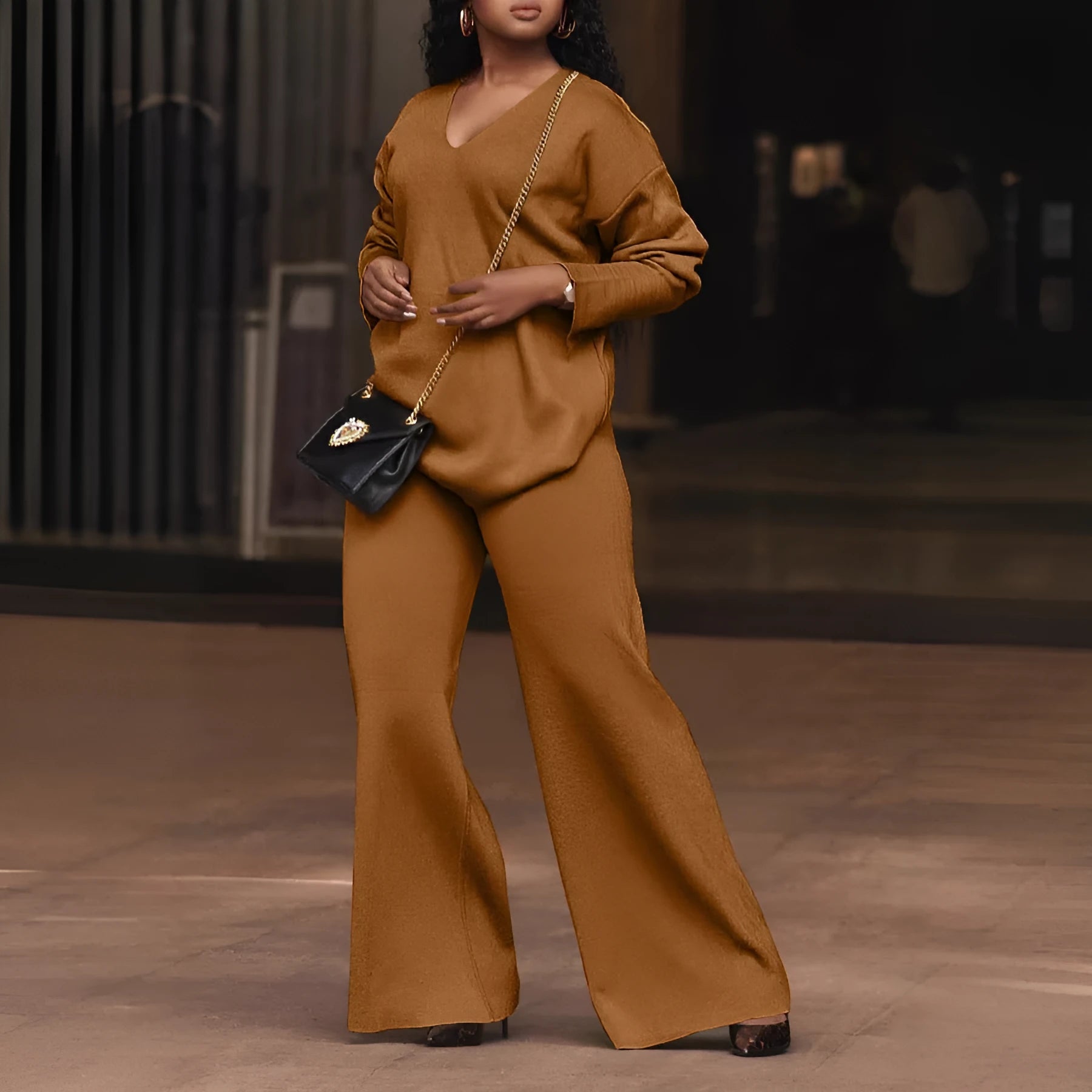Women's brown suede two-piece suit with split sleeves on top and matching trousers