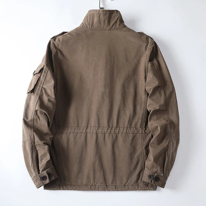 Men's loose-fit cotton zip jacket in light brown colour on a hanger, showing stand collar and front zip.