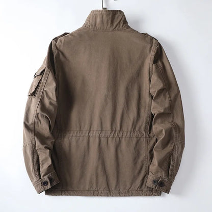 Men's loose-fit cotton zip jacket in light brown colour on a hanger, showing stand collar and front zip.