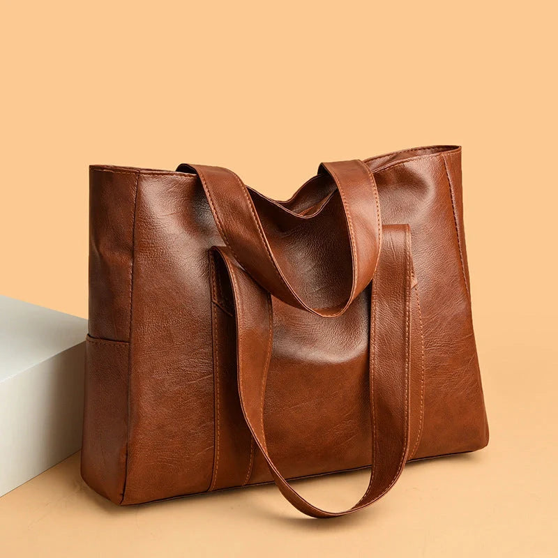 Stylish large capacity commuter shoulder bag in brown and black, perfect for autumn and winter fashion.