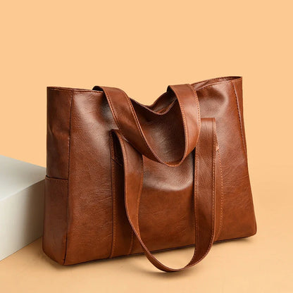 Stylish large capacity commuter shoulder bag in brown and black, perfect for autumn and winter fashion.