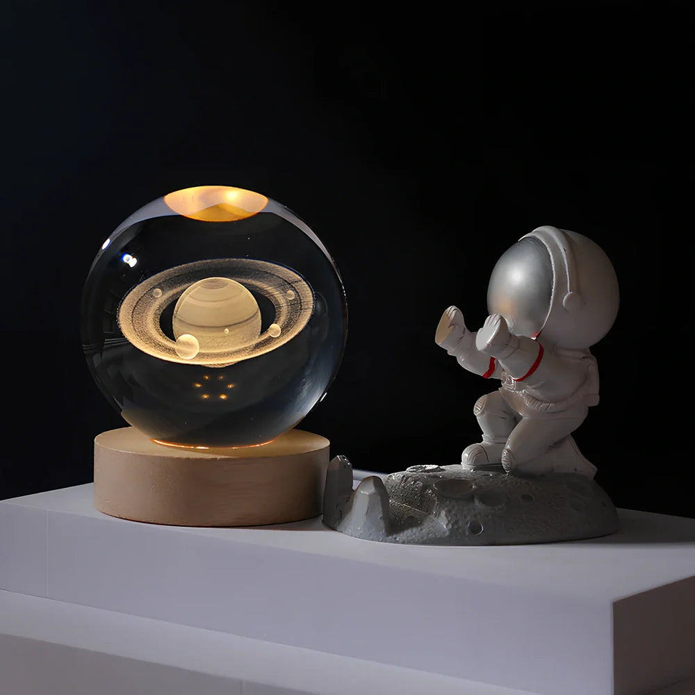 Cosmos Series crystal ball night light with wooden base and astronaut figure, showing Milky Way light pattern