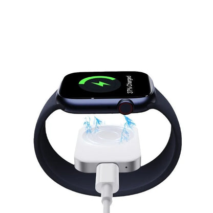 Compact black and white 3-in-1 magnetic wireless charger with integrated cables, shown next to a smartphone for scale.