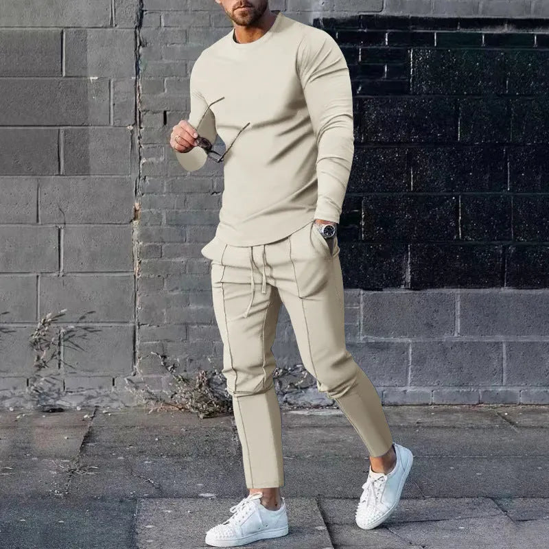 Men's solid colour two-piece lounge suit with long sleeve T-shirt and trousers in light grey.