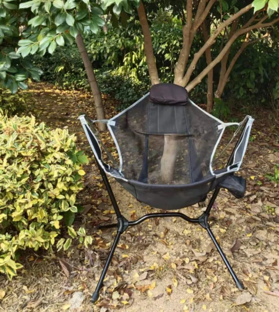 Green folding rocking chair unfolded on beach, 85cm tall with 60cm seat supporting 120kg