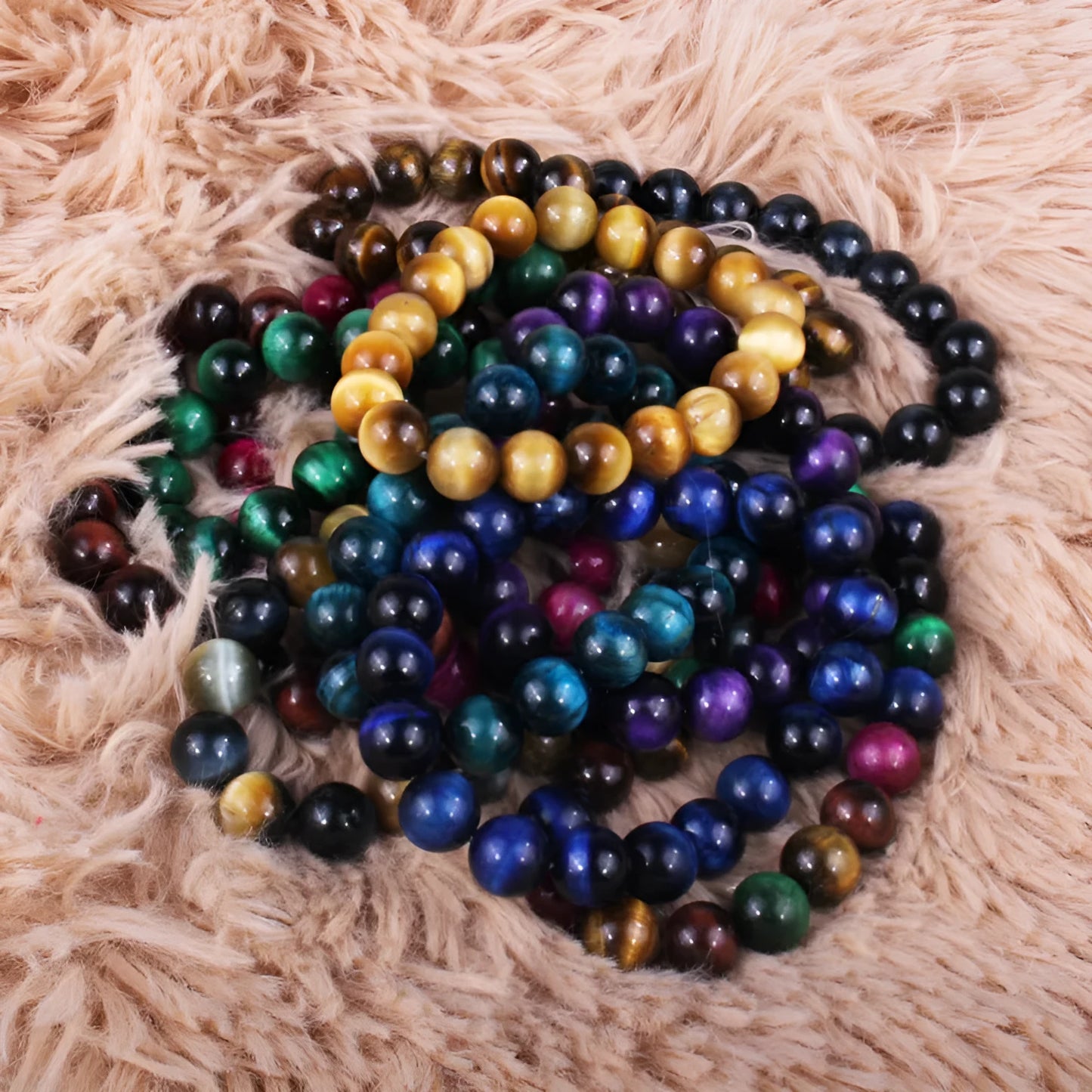 Natural tiger eye crystal bead bracelet showing round geometric beads on a wrist, available in multiple sizes and colour variations.